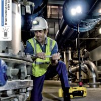 Portable Peli Rals lighting system used by a worker in a factory.